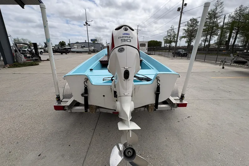 Slide: The Image of 1963 Boston Whaler 16 boat with Evinrude motor on trailer, parked outdoors. - 4