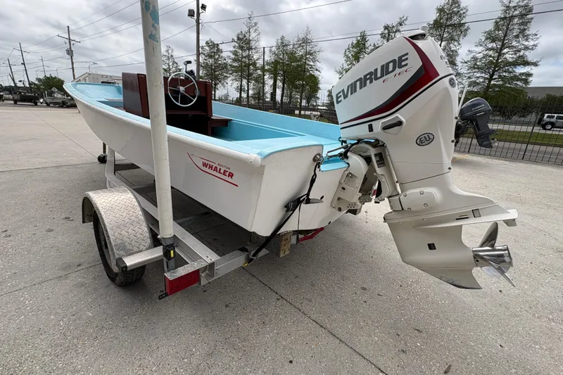 Slide: The Image of 1963 Boston Whaler 16 boat on trailer with Evinrude outboard motor. - 5