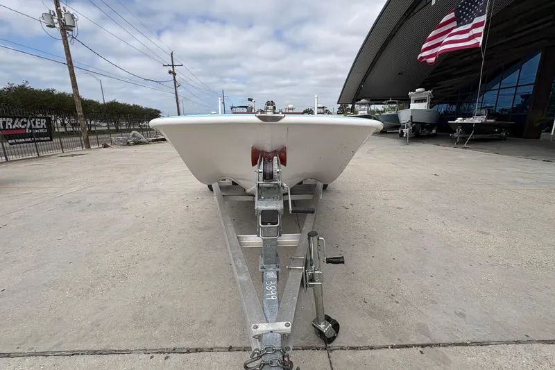 Slide: The Image of 1963 Boston Whaler 16 boat on trailer, outdoor display with American flag. - 8