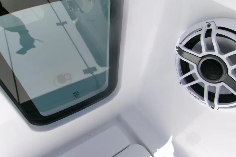 Slide: The Image of 2022 Sportsman Open 322 Center Console boat interior with speaker and glass hatch. - 10