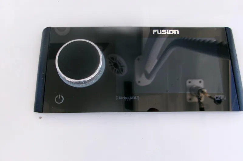 Slide: The Image of Fusion audio control panel on 2022 Sportsman Open 322 Center Console boat. - 11