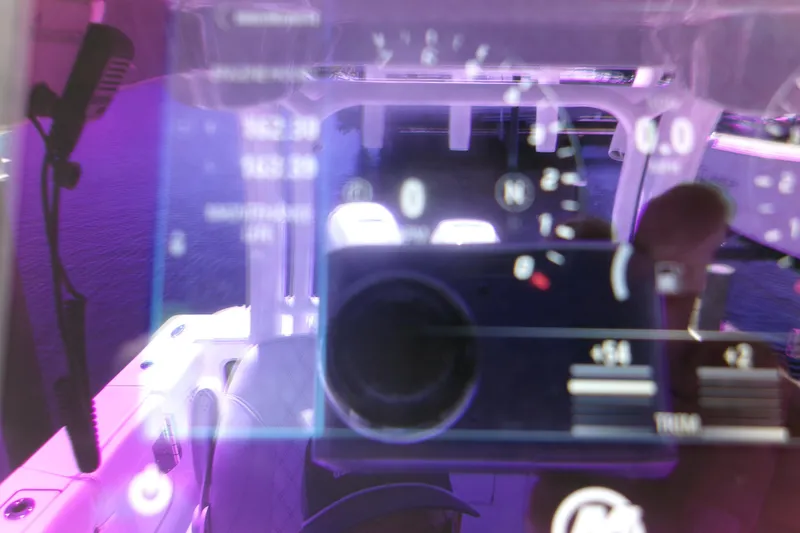 Slide: The Image of 2022 Sportsman Open 322 Center Console dashboard with digital display and purple lighting. - 16