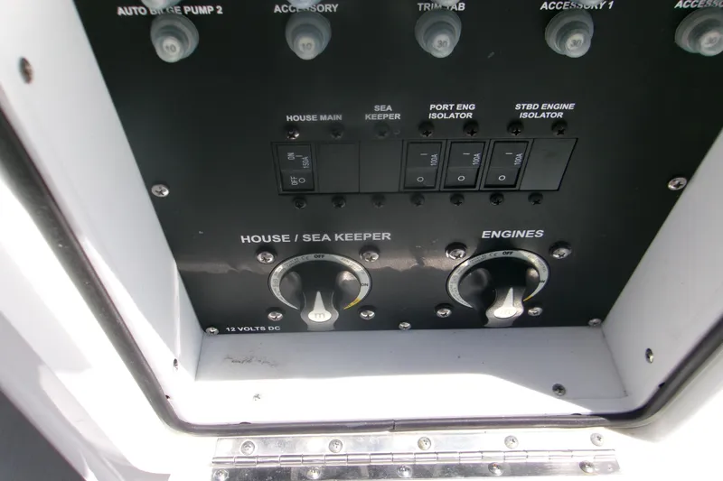 Slide: The Image of Control panel of a 2022 Sportsman Open 322 Center Console boat, featuring switches and dials. - 18