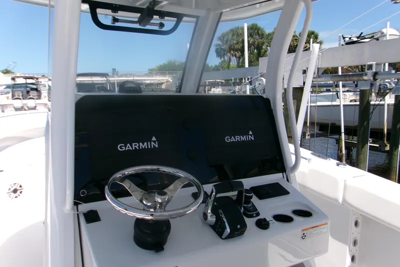Slide: The Image of 2022 Sportsman Open 322 Center Console helm with Garmin displays and controls. - 2