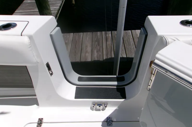 Slide: The Image of 2022 Sportsman Open 322 Center Console boat entryway with dock view. - 8