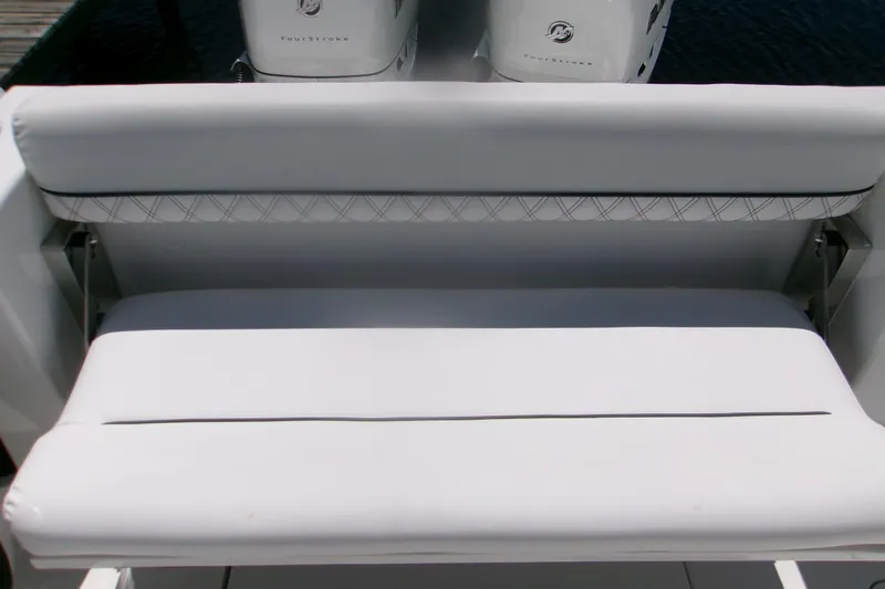 Slide: The Image of 2022 Sportsman Open 322 Center Console boat seating with white cushioned bench. - 9