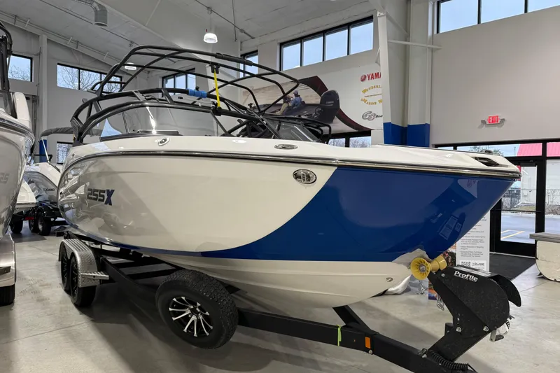 Slide: The Image of 2026 Yamaha Boats 255XE displayed indoors on a trailer, showcasing sleek design and modern features. - 15