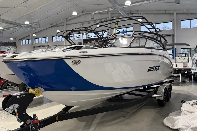 Slide: The Image of 2026 Yamaha Boats 255XE in showroom, featuring sleek design and modern architecture. - 16