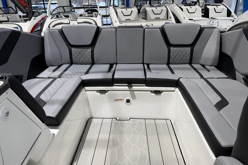 Slide: The Image of 2026 Yamaha Boats 255XE interior with sleek, modern seating and stylish design. - 19