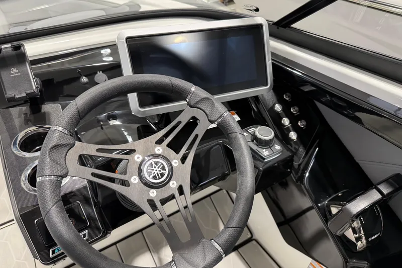 Slide: The Image of 2026 Yamaha Boats 255XE dashboard with steering wheel and touchscreen display. - 21