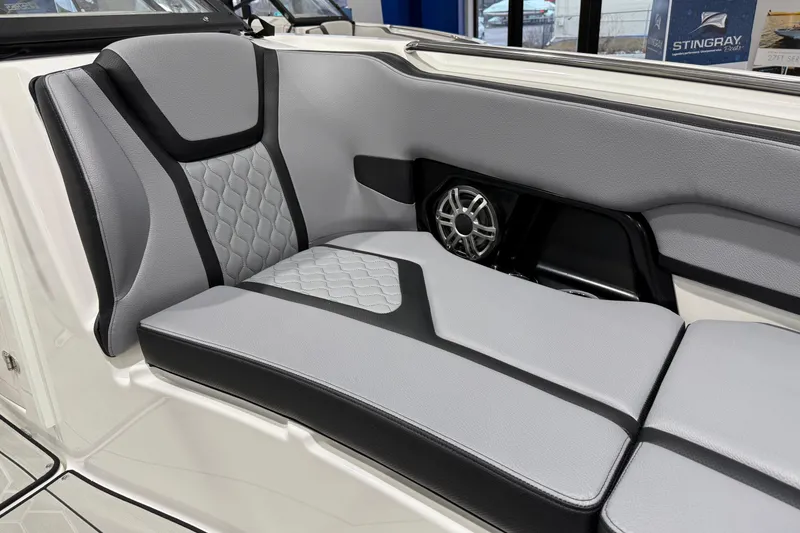 Slide: The Image of 2026 Yamaha Boats 255XE interior seating with gray and black upholstery, featuring a built-in speaker. - 24