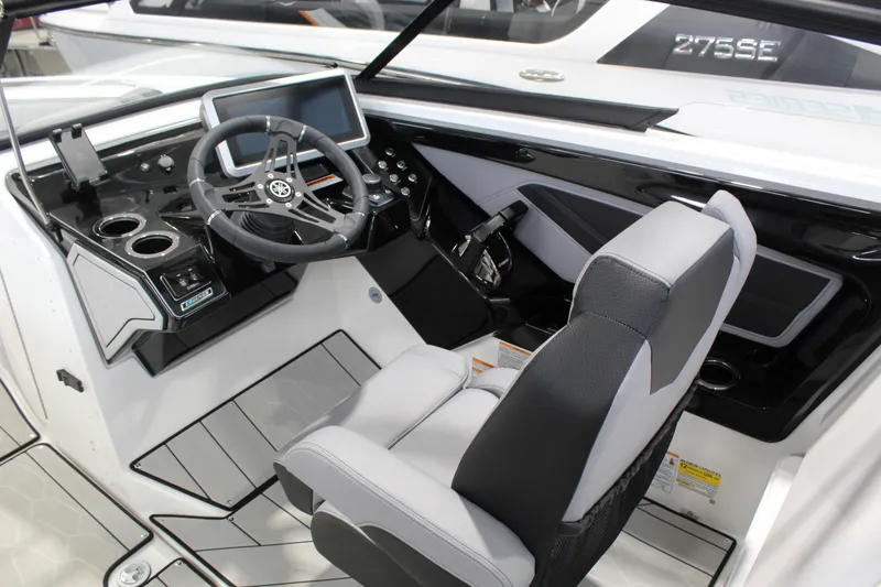 Slide: The Image of 2026 Yamaha Boats 255XE cockpit with modern steering, touchscreen, and comfortable seating. - 7