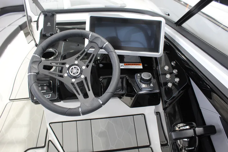Slide: The Image of 2026 Yamaha Boats 255XE dashboard with steering wheel and touchscreen display. - 8