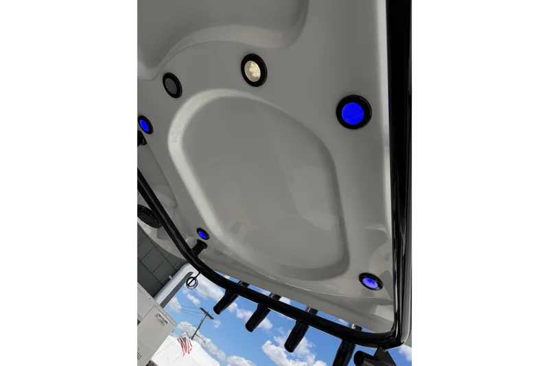 Slide: The Image of 2022 Seapro 239 DLX boat roof with blue LED lights against sky. - 12