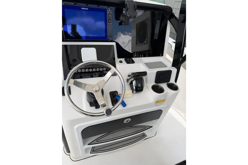 Slide: The Image of 2022 Seapro 239 DLX boat console with steering wheel and navigation display. - 17