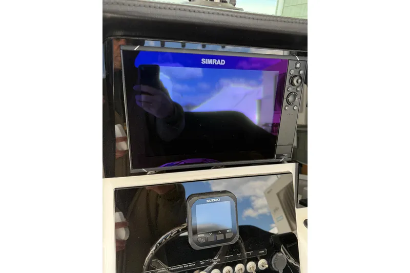 Slide: The Image of Simrad and Suzuki displays on 2022 Seapro 239 DLX boat dashboard. - 19