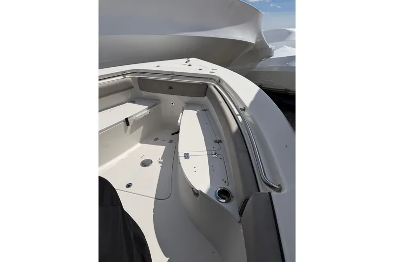 Slide: The Image of 2022 Seapro 239 DLX boat interior with seating and stainless steel railings. - 2