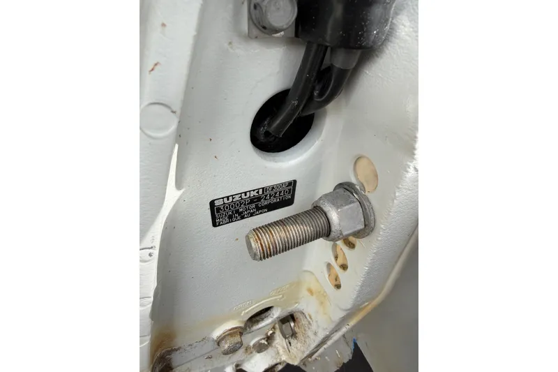 Slide: The Image of Close-up of a 2022 Seapro 239 DLX boat engine bolt and Suzuki label. - 20