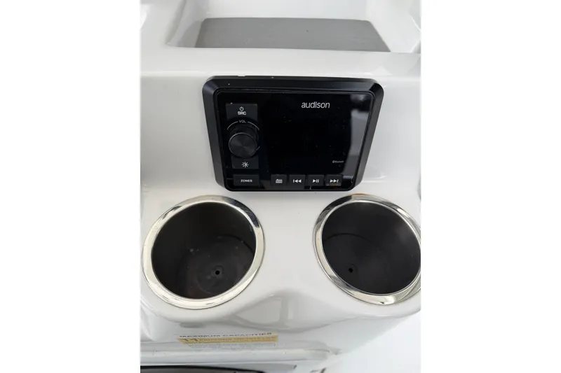 Slide: The Image of 2022 Seapro 239 DLX boat console with Audison stereo and dual cup holders. - 21