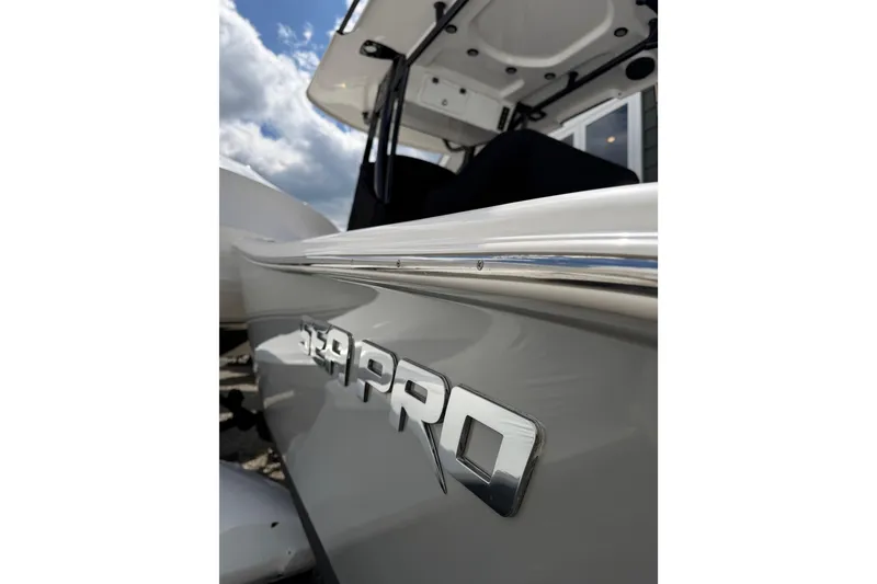 Slide: The Image of 2022 Seapro 239 DLX boat with sleek design and logo detail. - 22