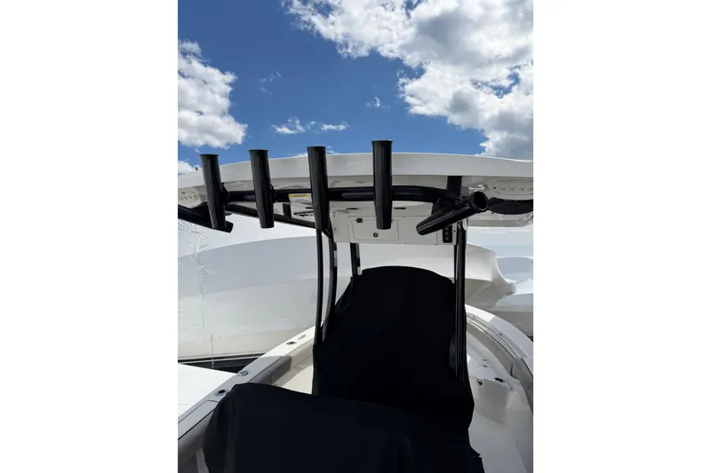 Slide: The Image of 2022 Seapro 239 DLX boat with rod holders under a clear blue sky. - 23