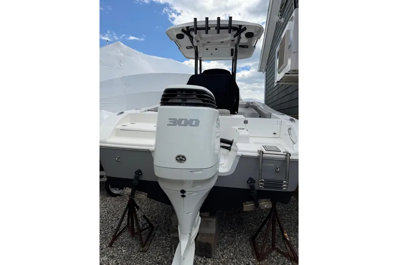 Slide: The Image of 2022 Seapro 239 DLX boat with powerful 300 horsepower engine, docked outdoors. - 3