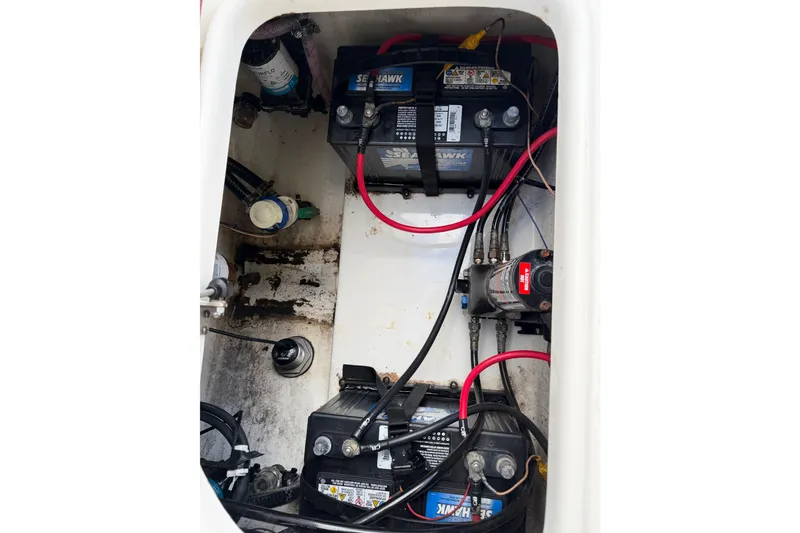 Slide: The Image of 2022 Seapro 239 DLX boat battery compartment with wiring and components. - 9