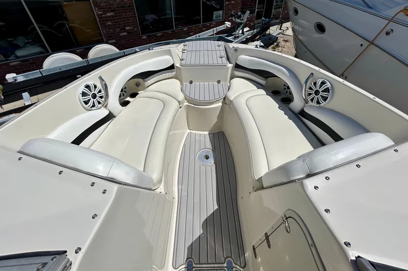 Slide: The Image of 2012 Stingray 234 LR boat interior with white seating and marine speakers. - 10