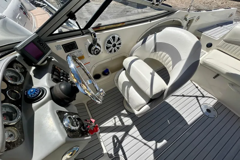Slide: The Image of Interior of 2012 Stingray 234 LR boat with steering wheel and control panel. - 11