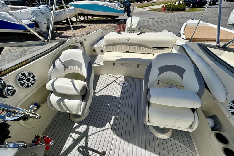 Slide: The Image of Interior of a 2012 Stingray 234 LR boat with white seating and modern design. - 12