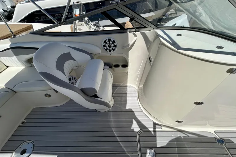 Slide: The Image of 2012 Stingray 234 LR boat interior with white seating and speaker system. - 16
