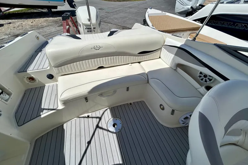 Slide: The Image of 2012 Stingray 234 LR boat interior with white seating and gray flooring. - 17