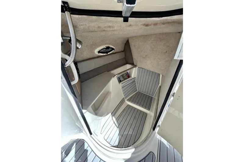 Slide: The Image of Interior cabin of a 2012 Stingray 234 LR boat with seating and storage. - 18