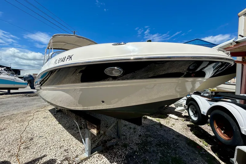 Slide: The Image of 2012 Stingray 234 LR boat on trailer under clear blue sky. - 2