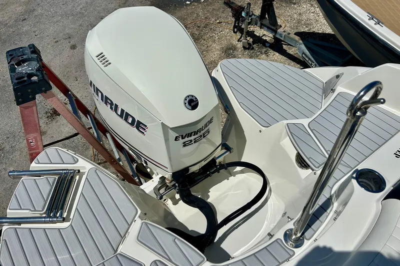 Slide: The Image of 2012 Stingray 234 LR boat with Evinrude 225 engine, docked on a sunny day. - 22