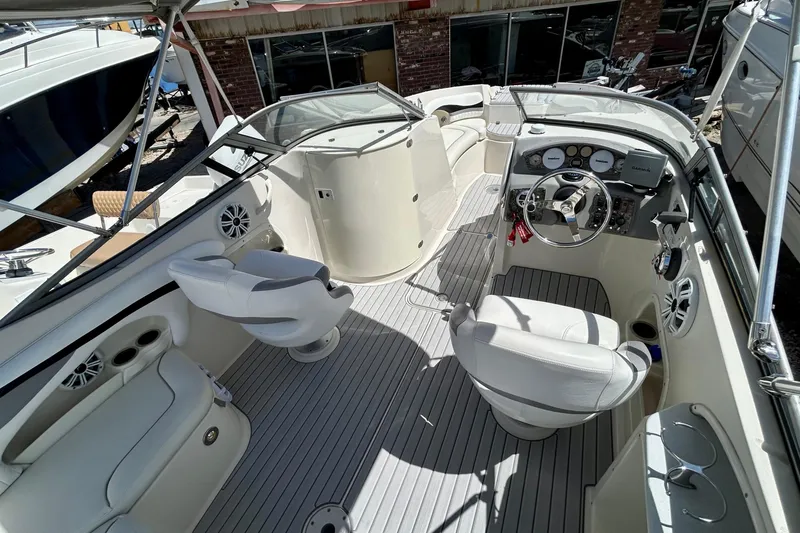 Slide: The Image of 2012 Stingray 234 LR boat interior with steering wheel, seating, and dashboard controls. - 7