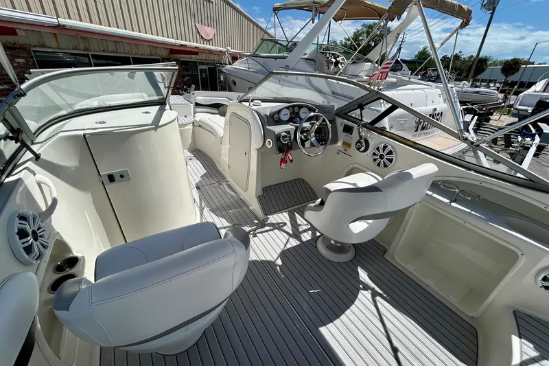 Slide: The Image of Interior view of a 2012 Stingray 234 LR boat with seating and dashboard. - 8