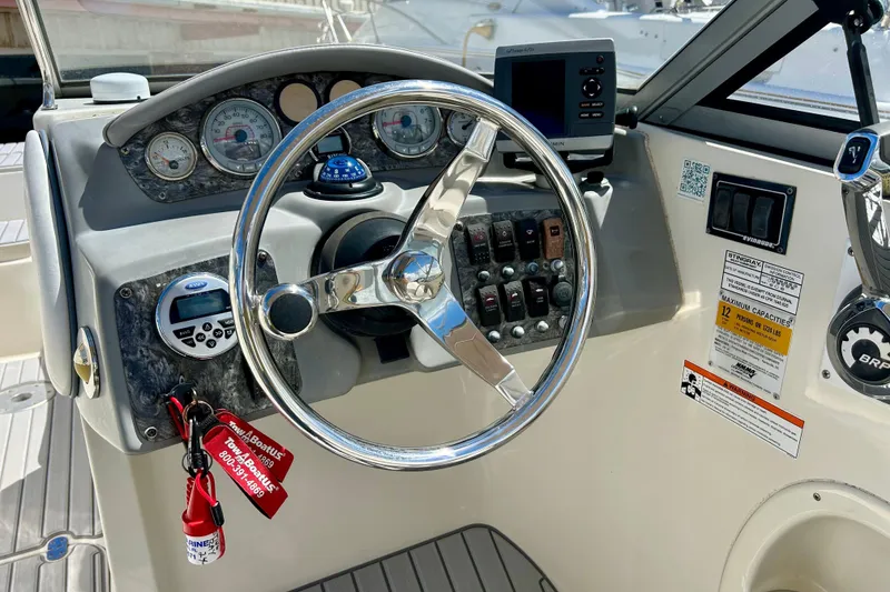 Slide: The Image of Steering console of a 2012 Stingray 234 LR boat with gauges and controls. - 9