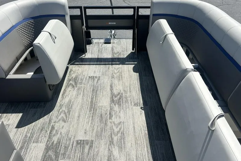 Slide: The Image of 2023 Angler Qwest 8524 Pro Family Fish Triple Tube boat interior with gray seating and flooring. - 10