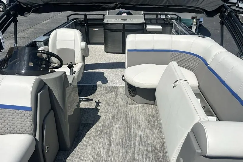 Slide: The Image of 2023 Angler Qwest 8524 Pro Family Fish Triple Tube interior with seating and helm. - 11