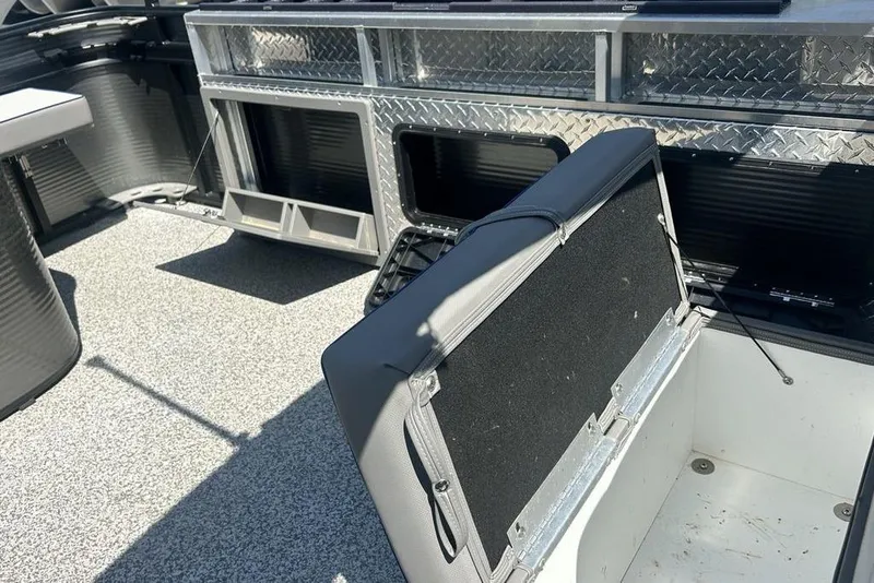 Slide: The Image of 2023 Angler Qwest 8524 Pro Family Fish Triple Tube boat interior with storage compartments. - 14