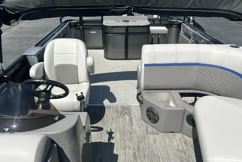 Slide: The Image of 2023 Angler Qwest 8524 Pro Family Fish Triple Tube interior with seating and helm. - 15