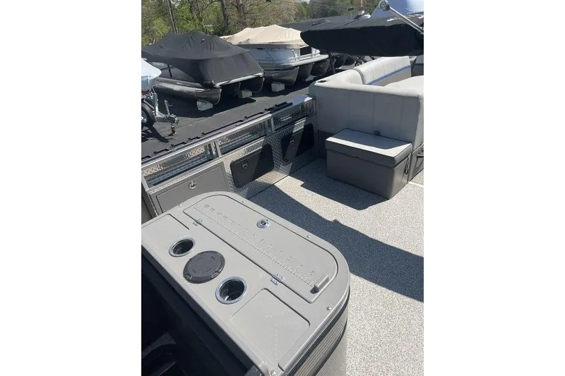 Slide: The Image of 2023 Angler Qwest 8524 Pro Family Fish Triple Tube interior with seating and storage. - 6