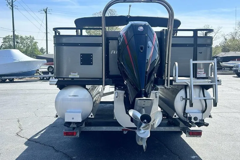 Slide: The Image of 2023 Angler Qwest 8524 Pro Family Fish Triple Tube pontoon boat, rear view with motor and ladder. - 8