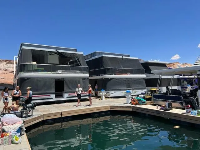 Slide: The Image of 2007 Sumerset Fellowship Share #5 houseboats docked with people enjoying the sunny day. - 4