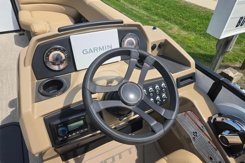 Slide: The Image of Steering console of 2026 Evotti 523QL boat with Garmin display and controls. - 16