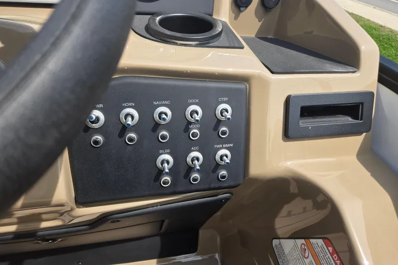 Slide: The Image of Control panel of 2026 Evotti 523QL boat with switches and cup holder. - 19