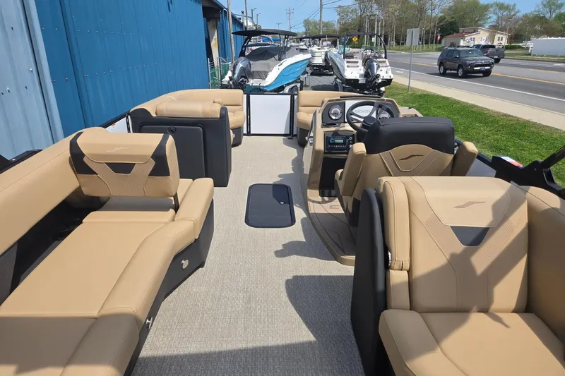 Slide: The Image of 2026 Evotti 523QL boat interior with beige seating, steering console, and outdoor setting. - 27