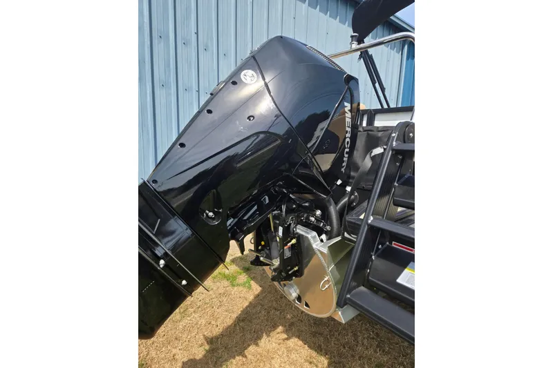 Slide: The Image of Black Mercury outboard motor on Evotti 523QL, 2026 model, near blue metal wall. - 42