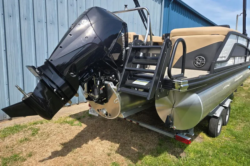 Slide: The Image of 2026 Evotti 523QL pontoon boat with powerful Mercury outboard motor, parked on trailer. - 5